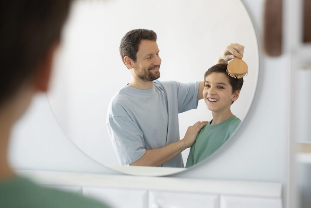 side-view-smiley-father-brushing-kid-s-hair
